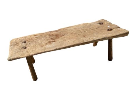 A large rustric wooden pig bench on later tapered splayed supports (signs of previous old worm), 145 x 52 x 48cm 