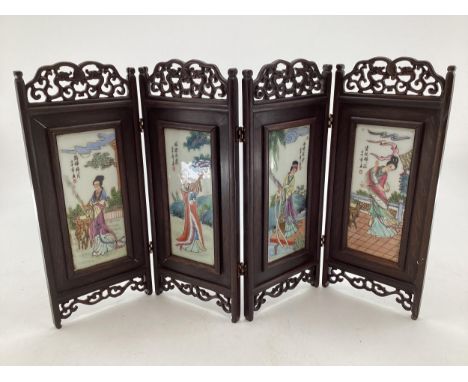 An early C0th four section desk top miniature screen with four ceramic panels to a stylised hardwood mount (good order) 