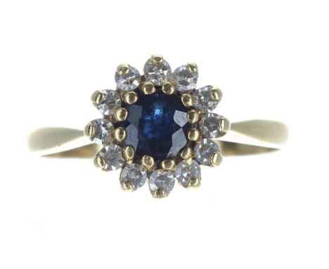 18ct sapphire and diamond circular cluster ring, the sapphire 0.20ct approx, in a surround of round brilliant-cut diamonds, 9