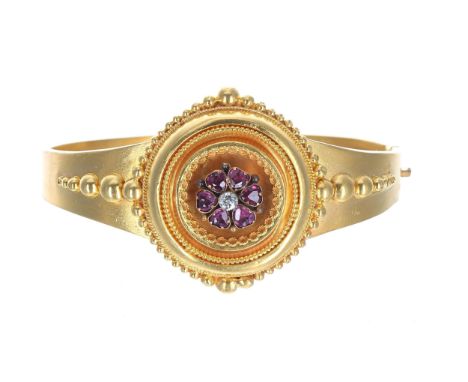 Victorian yellow metal hinged mourning bangle, with a gem set and diamond central cluster within a rope and beadwork border, 