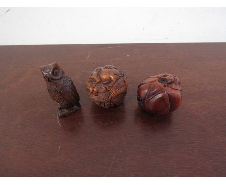 Three signed carved wood netsuke of spheres and owl 