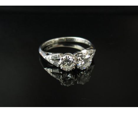 A platinum ring set with two .50ct approx diamonds flanked by tapered diamonds to shoulders. Size P/Q, 3.2g