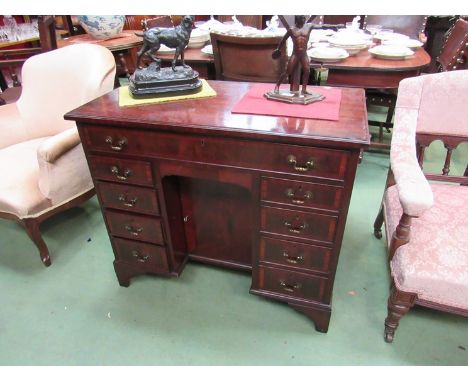 A George III revival crossbanded mahogany lady's twin pedestal desk of ten drawers with single door dog-kennel cupboard on br