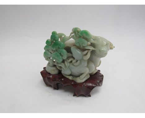 A late 19th Century Jade figural group of an Oxen with calf in foliage on wooden stand, 13cm long