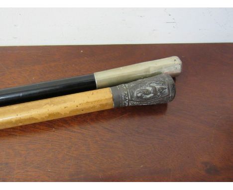 An ebony swagger stick and Victorian walking cane with Indian deity panelled top 