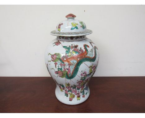 A pair of 19th Century Chinese lidded vases of bulbous form with hand painted enamel scenes of a dwelling interior, 42cm tall