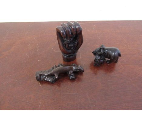 Three carved wood netsuke of elephants, monkey in hand and lizard on branch 