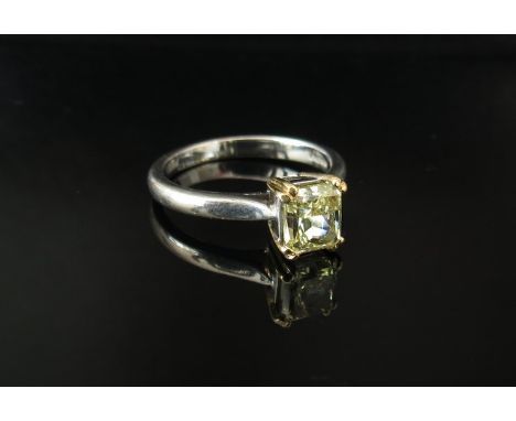 An 18ct white gold ring set with set a single canary yellow diamond emerald cut 5.9mm x 5.3mm, 1.01ct in claw mount, size L 3