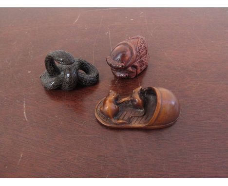 Three signed carved wood netsuke of beetles, serpent and cat and mouse on a slipper 