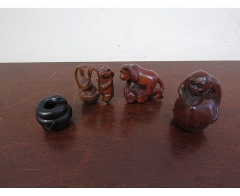 Four carved wood netsuke, serpent, monkeys and rabbits 
