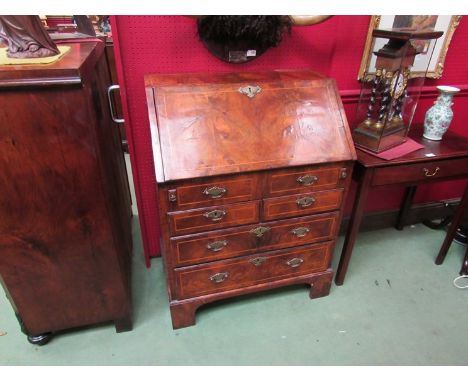 A George II walnut bureau, drop-flap revealing fitted interior, two faux drawers with two short drawers over two long drawers