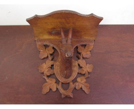 An early 20th Century black forest carved wall bracket with deer's head detail