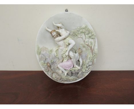 A continental ceramic wall plaque of three classic figures (some damage to foot) 