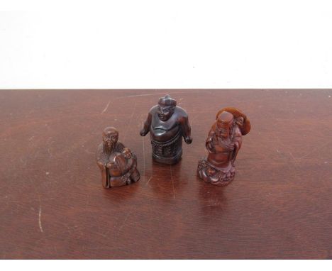 Three signed carved wood netsuke of figures and sage 