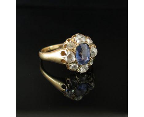 A gold ring set with old cut diamonds and sapphire to centre, marked 18c. Size O, 4.7g