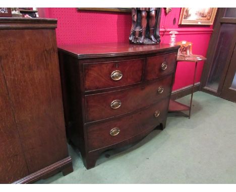 A circa 1840 flame mahogany bow front chest of two short over two long drawers with brass oval plate handles on bracket feet