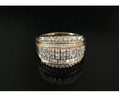 A 9ct gold ring set with multiple bands of brilliant and baguette cut diamonds. Size P, 5.4g