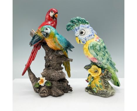 A vibrant pair of parrot figurines, featuring a colorful ceramic macaw perched on a naturalistic tree trunk and a lively Stan