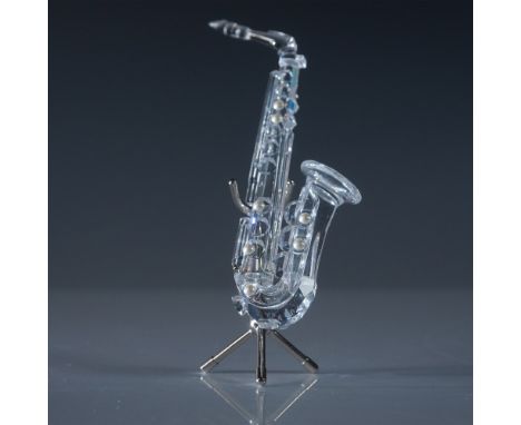 A stunning Swarovski Silver Crystal saxophone figurine, designed with intricate detailing, featuring a faceted crystal body a