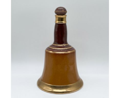 Royal Doulton ceramic decanter in the shape of a bell, crafted for Bells Scotch Whisky. The decanter features a rich brown gl