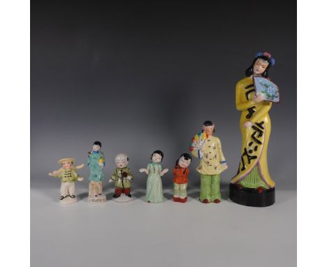 A collection of seven vintage porcelain figurines, featuring a range of characters in traditional attire. The set includes a 