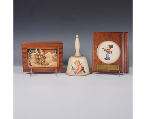 A charming trio of Goebel Hummel collectibles, featuring: 1987 Annual Bell  This porcelain bell showcases a young boy paintin