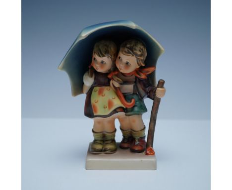 Charming Goebel Hummel figurine titled Stormy Weather, featuring a young boy and girl huddled together under an umbrella as t