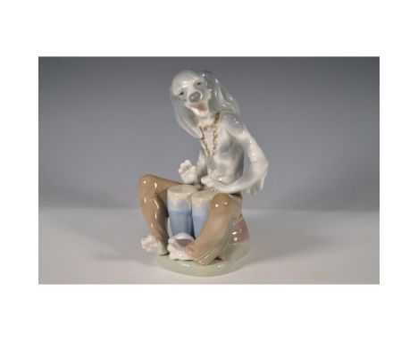 Presenting a delightful Lladro porcelain figurine, model 1001156, titled Dog Playing Bongos. This charming piece, designed by