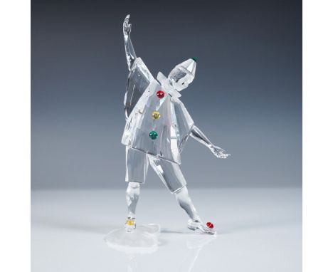 A masquerade clown with open arms is adorned in red, yellow, and green accent crystals, featuring a black teardrop on his fac