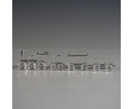 A stunning four-piece Swarovski Silver Crystal train set featuring a locomotive and three coordinating cars, each crafted fro