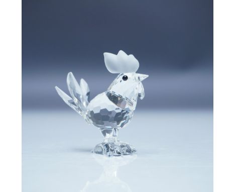 This retired Swarovski crystal figurine is part of the 'Barnyard Friends' collection. The rooster is crafted from clear facet