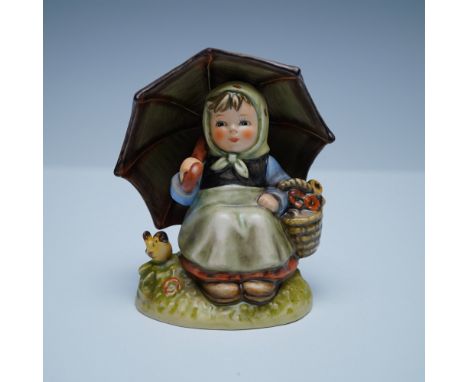 A charming Goebel Hummel Special Edition No. 9 "Smiling Through" figurine depicting a young child holding an umbrella with a 