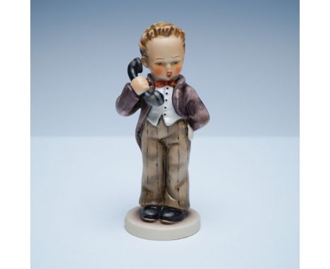 This charming Goebel Hummel figurine, titled Hello Chef, depicts a young boy dressed in a formal brown coat and vest, speakin