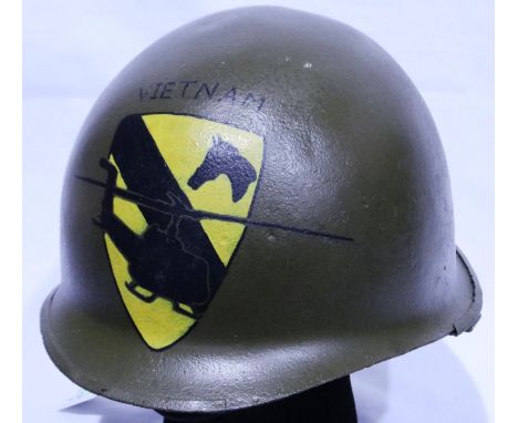 An American Vietnam war period M1 helmet, later painted with 1st Cavalry Division emblem. P&amp;P Group 2 (£18+VAT for the fi