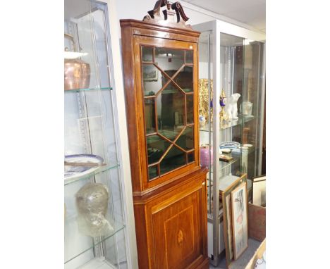 AN EDWARDIAN MAHOGANY TWO TIER CORNER CUPBOARD inlaid with satinwood bandings and boxwood stringing, the upper part with scro