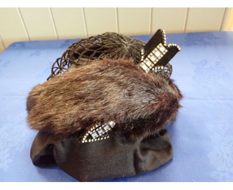 CHRISTIAN DIOR: A BLACK FUR SCULL CAP/ HAT with diamante arrow decoration, some shedding
