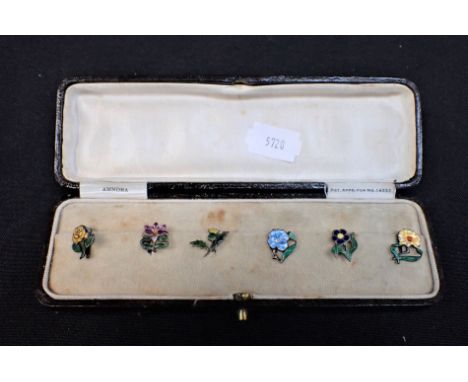 A BOXED SET OF DRESS CLIPS in the form of enamel flowers
