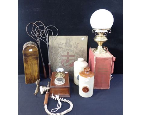 A REPRODUCTION WALL TELEPHONE together with two ceramic hot water bottles, an engraved heraldic plate, a brass lamp and other