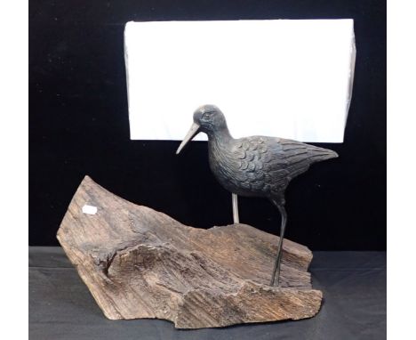 A LAMP MOUNTED WITH A CARVED ESTUARY BIRD on a driftwood base