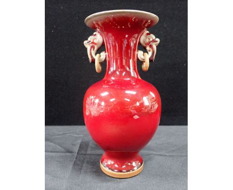 A CHINESE SANG DE BOEUF VASE with ring handles 22cm height