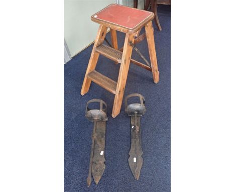 A PAIR OF VINTAGE FOLDING STEPS with red vinyl top and white banding with a pair of medieval style heavy wrought iron wall sc