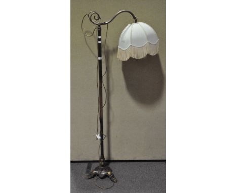 A brass standard lamp, with swan neck arm and tripod base, 169cm high