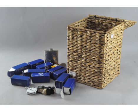 A wicker lidded basket containing a mixed assortment of items, including a pewter hip flask and Corgi cars 