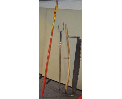 A group of tools, including a pitchfork and other tools