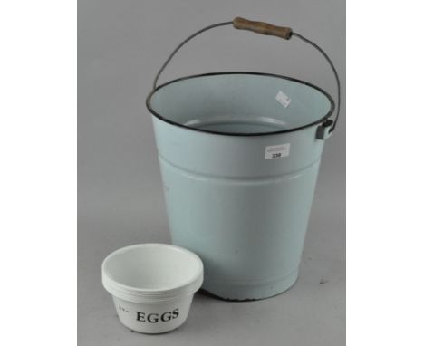 A vintage enamel bucket, 30cm high; with a group of egg dishes