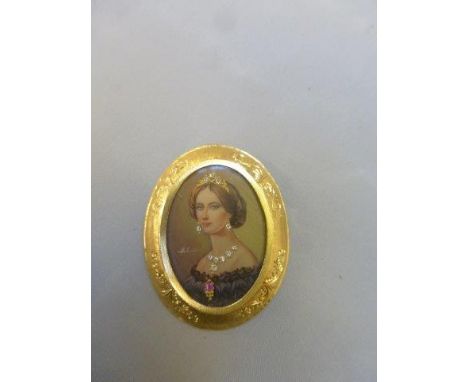 A miniature portrait of a lady wearing a tiara, necklace and earrings, on ivory (possibly), surmounted with diamonds, and set