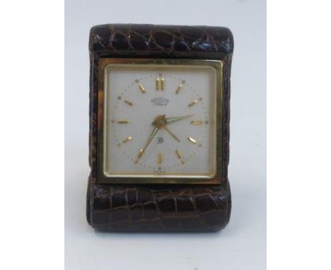 A leather cased Angelus Lilliput travel alarm clock.