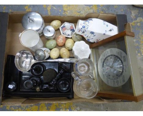 An assortment of mixed collectables including stone eggs, ebonised dressing table set and a silver plated soup ladle.