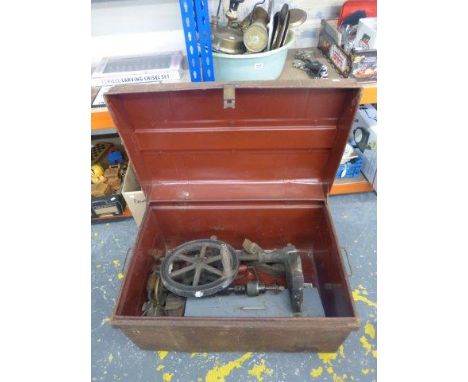 A tin lidded trunk with an assortment of early tools, including wooden planes and a bench hand turned drill.