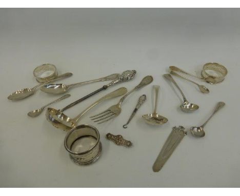 An assortment of silver flatware including three silver napkin rings, an Art Nouveau page marker, sugar sifter ladles etc.